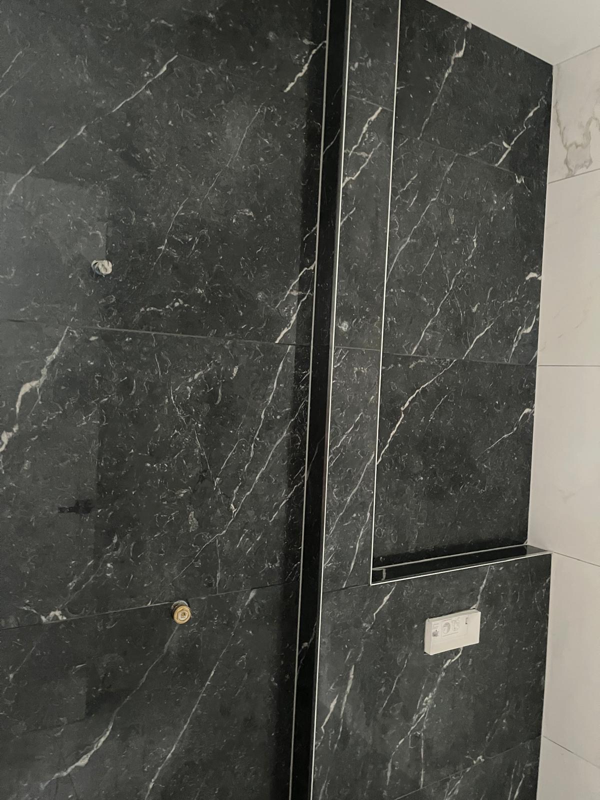 Real bathroom renovation — black marble tiling with niche, Auckland